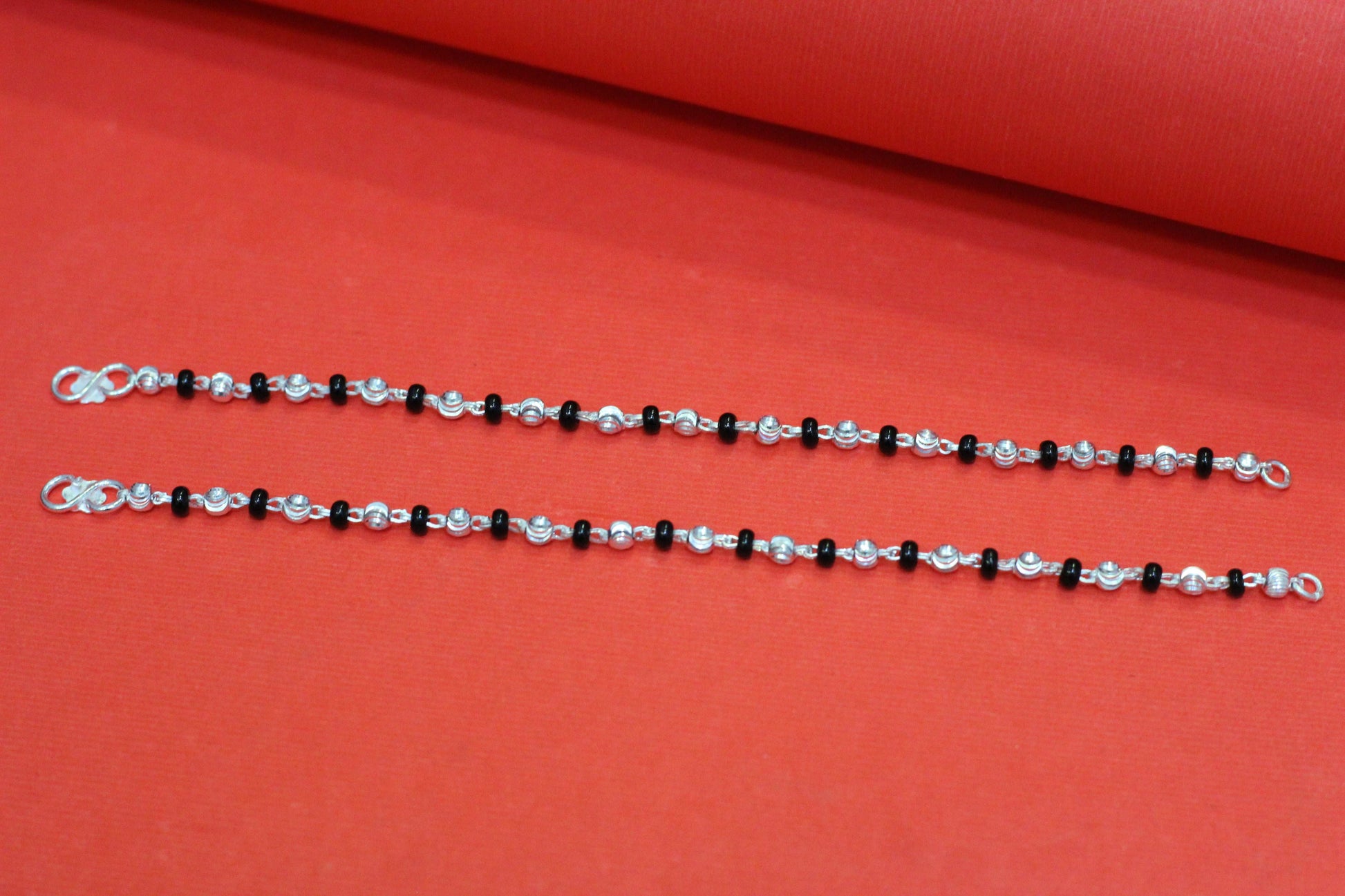 Silver nazariya one black beed and one silver ball