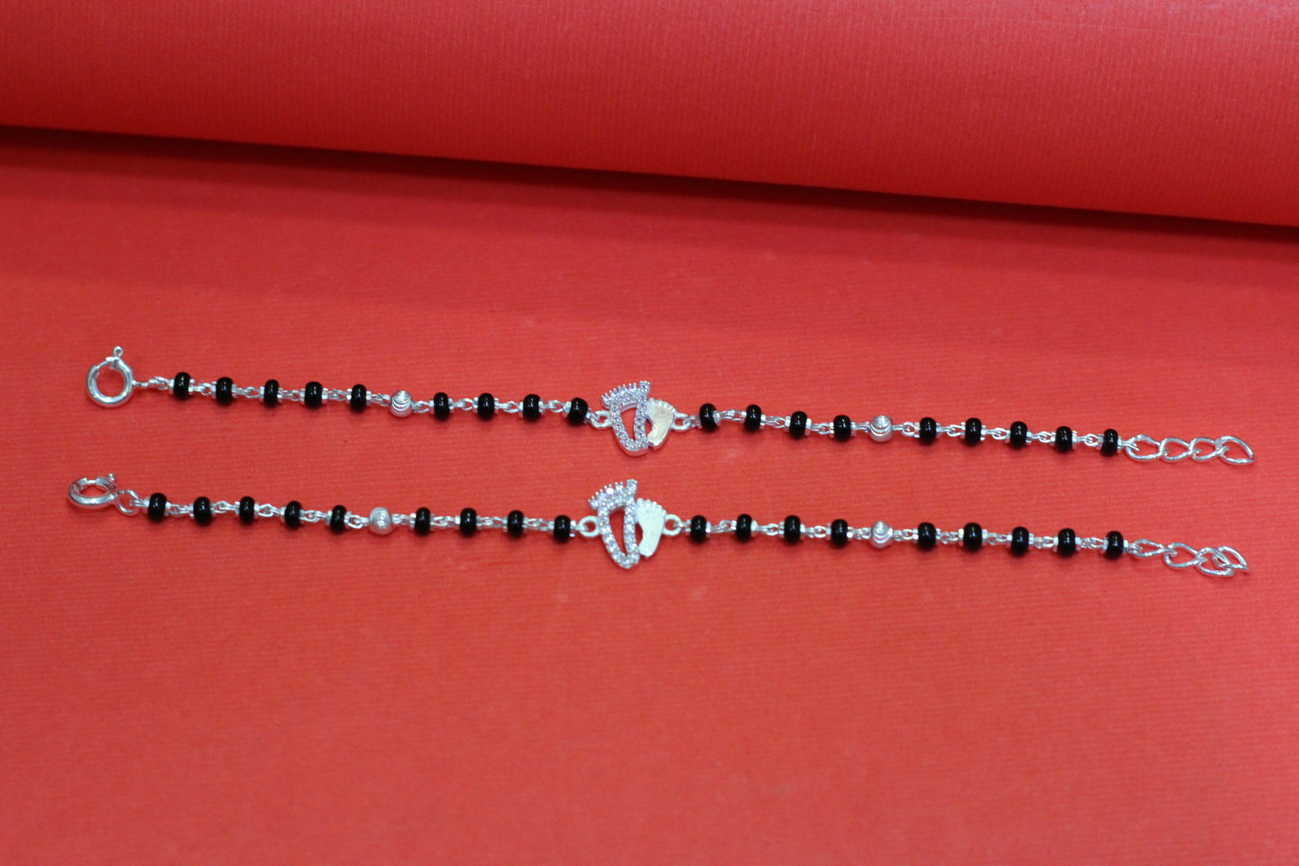 Silver nazariya with footprint charm at the center