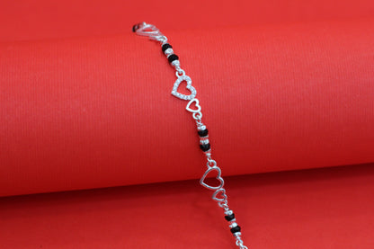 Elegant Silver Interlocking Hearts Bracelet with Black Beads and Cubic Zirconia