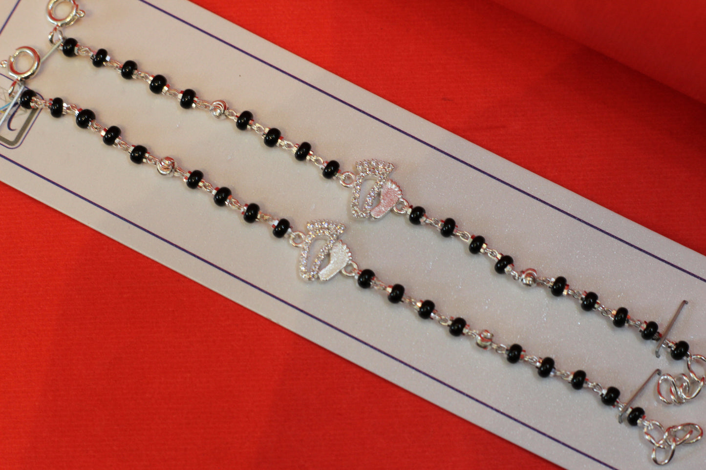 Silver nazariya with footprint charm at the center