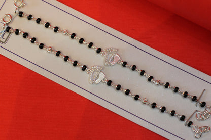 Silver nazariya with footprint charm at the center
