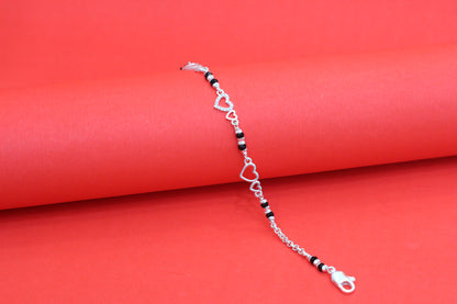 Elegant Silver Interlocking Hearts Bracelet with Black Beads and Cubic Zirconia